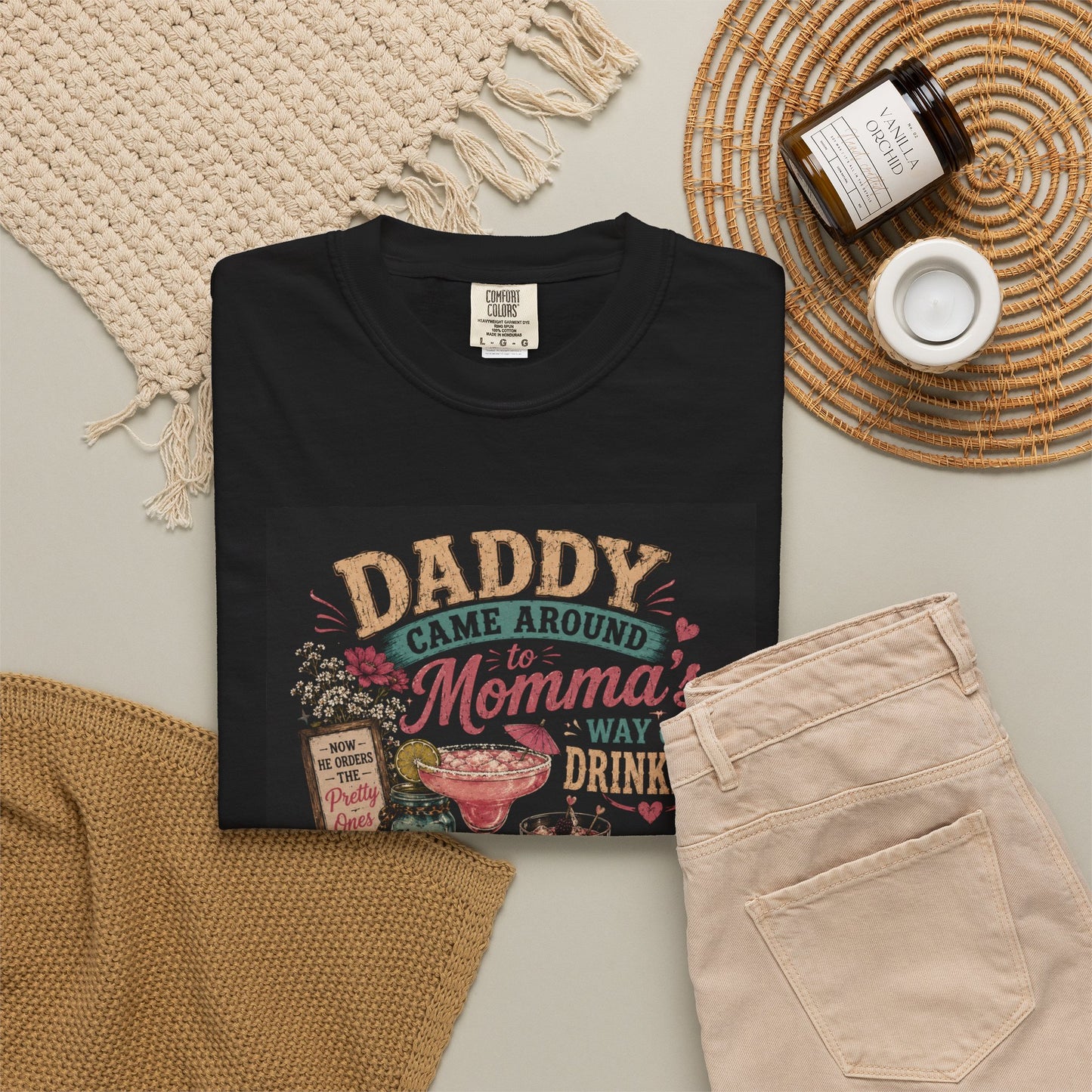 Black t-shirt featuring a humorous graphic that reads "Daddy Came Around to Momma's Way of Drinking," styled with colorful dr