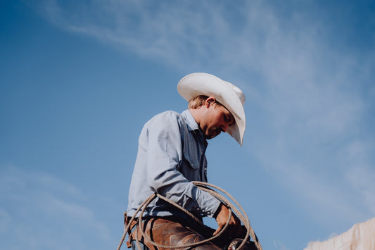 a man in a cowboy hat riding a horse