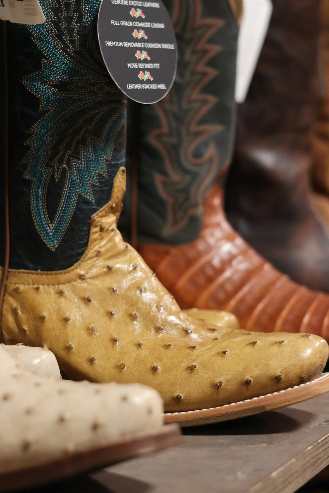 A row of cowboy boots sitting on top of a wooden shelf