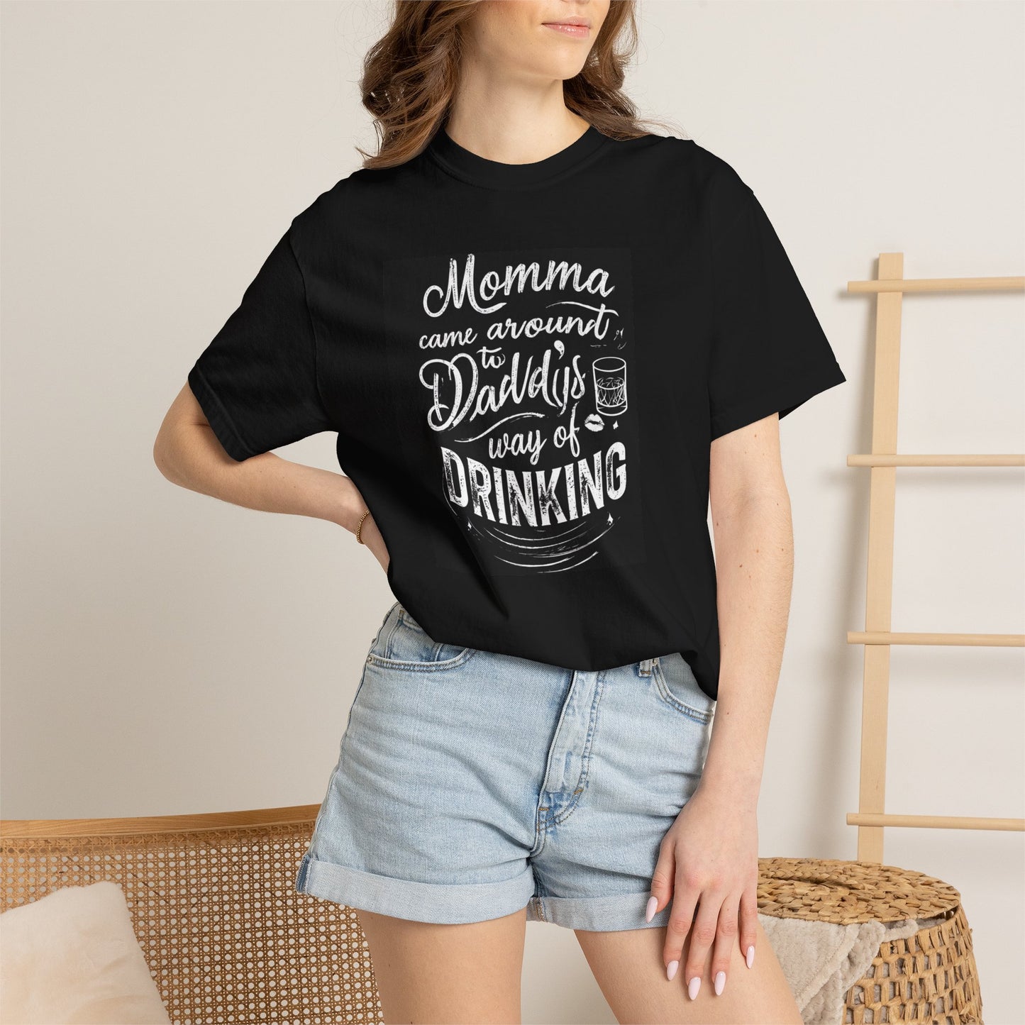 Unisex Drinking T-shirt in black featuring a humorous graphic about drinking, paired with denim shorts.