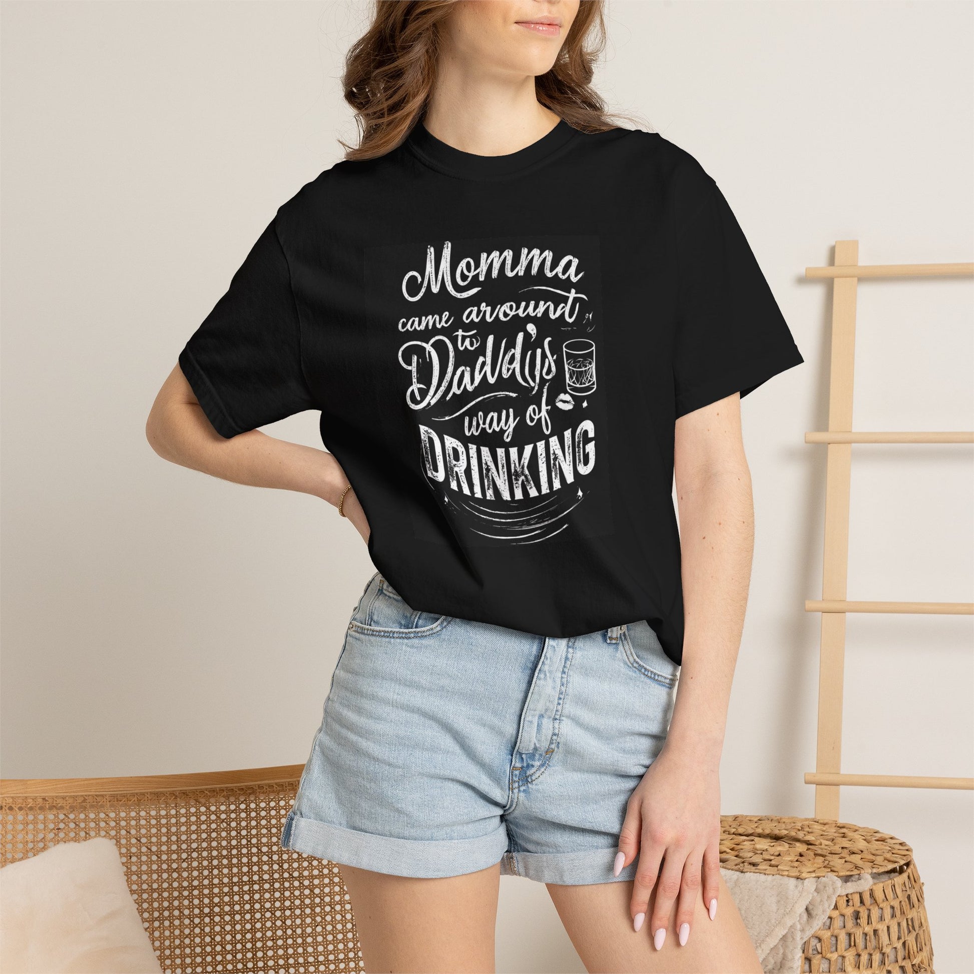 Unisex Drinking T-shirt in black featuring a humorous graphic about drinking, paired with denim shorts.