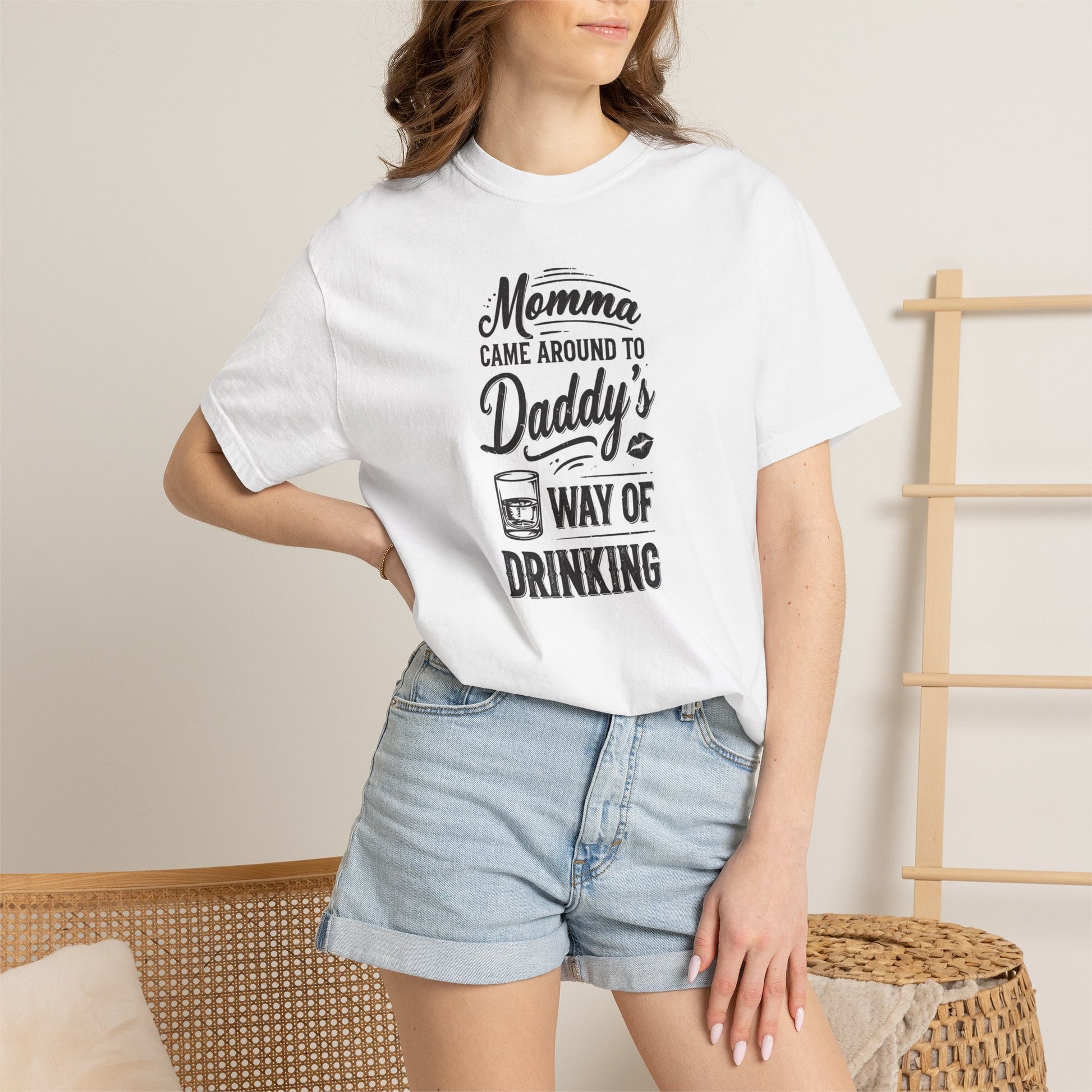 Unisex Way of Drinking T-shirt in white with playful text design, paired with denim shorts, model posing indoors.