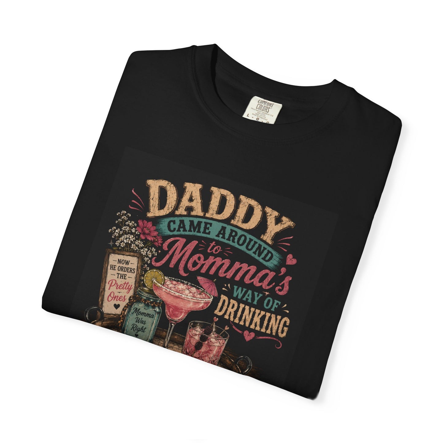 Black T-shirt featuring the phrase "Daddy Came Around to Momma's Way of Drinking" with colorful graphics of cocktails and flo