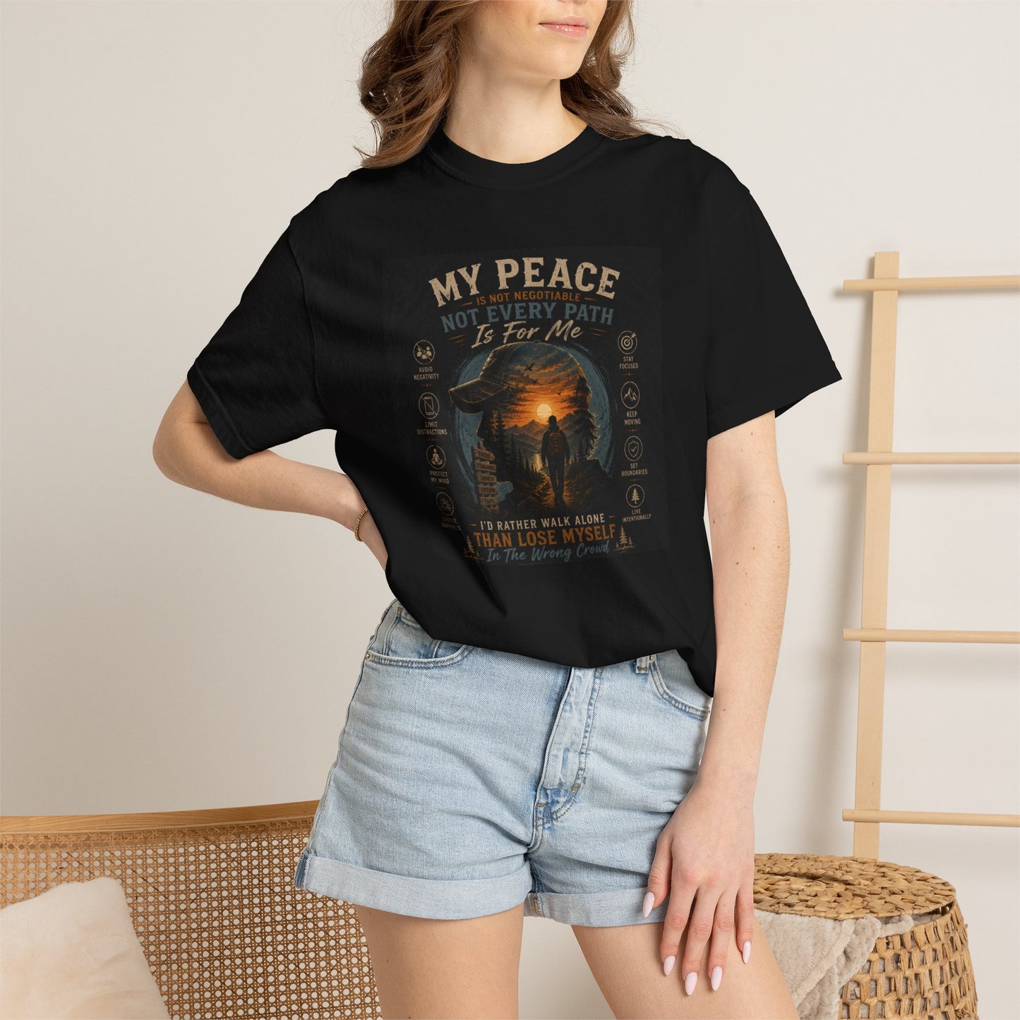 Unisex My Peace Tee in black, featuring a graphic design with text and a sunset scene, paired with denim shorts.