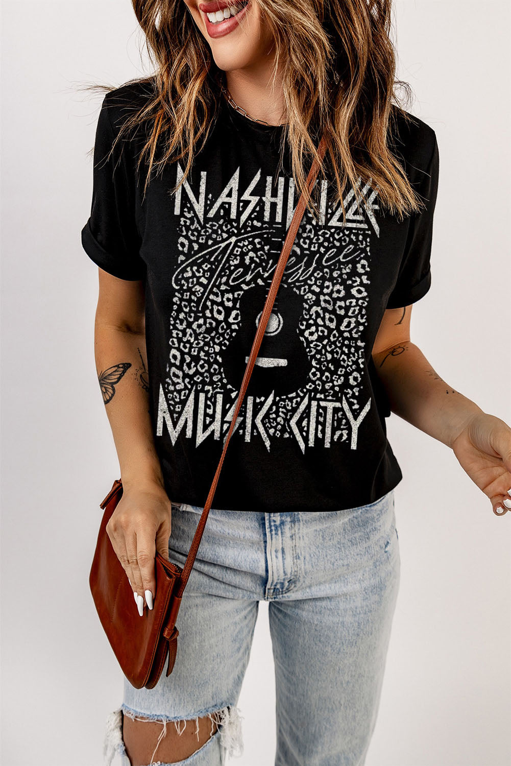 Black Graphic Cuffed Sleeve Round Neck Tee featuring "Nashville Music City" design with leopard print accents, paired with de