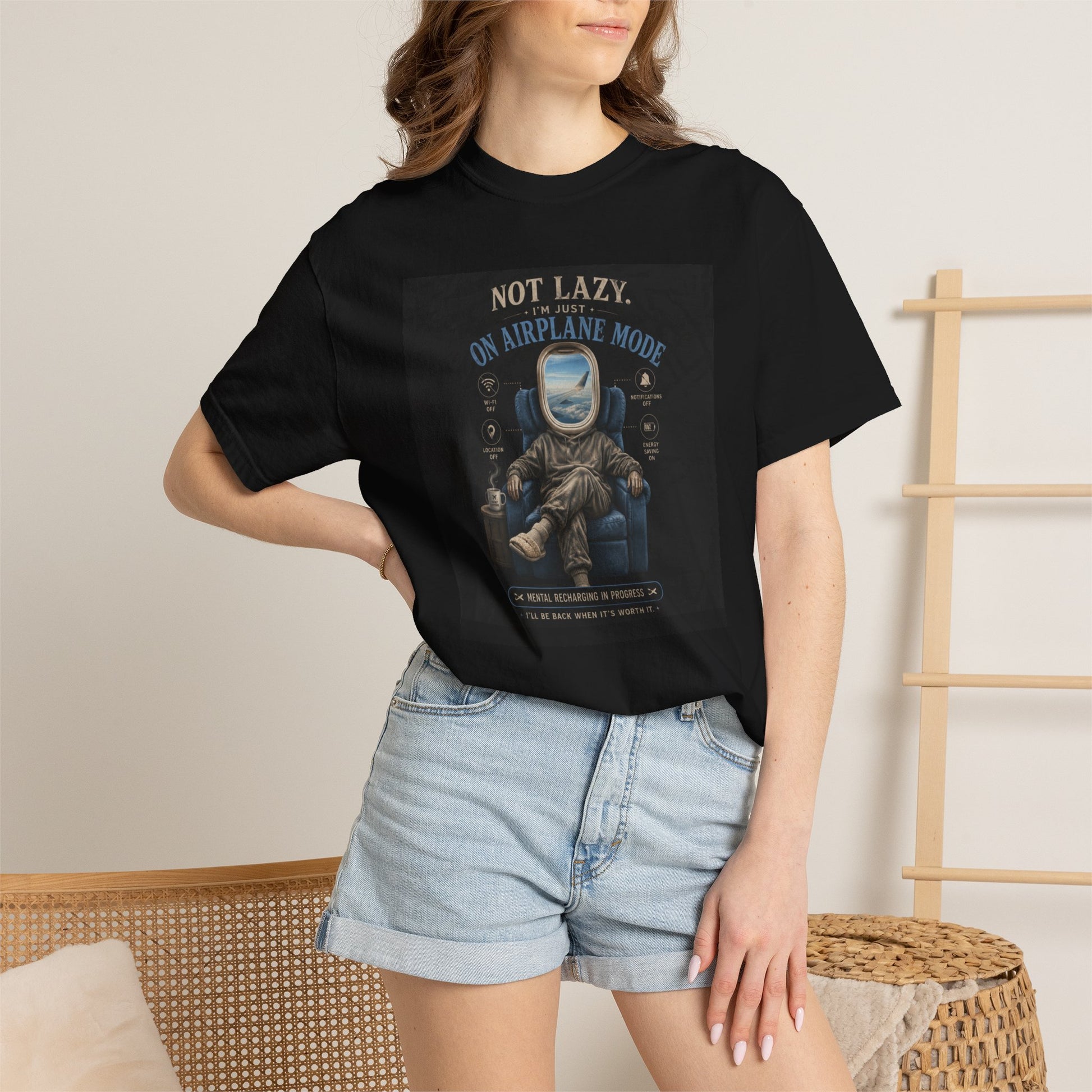 Black t-shirt featuring a humorous graphic of an astronaut with the text "Not Lazy, Just on Airplane Mode," styled for travel
