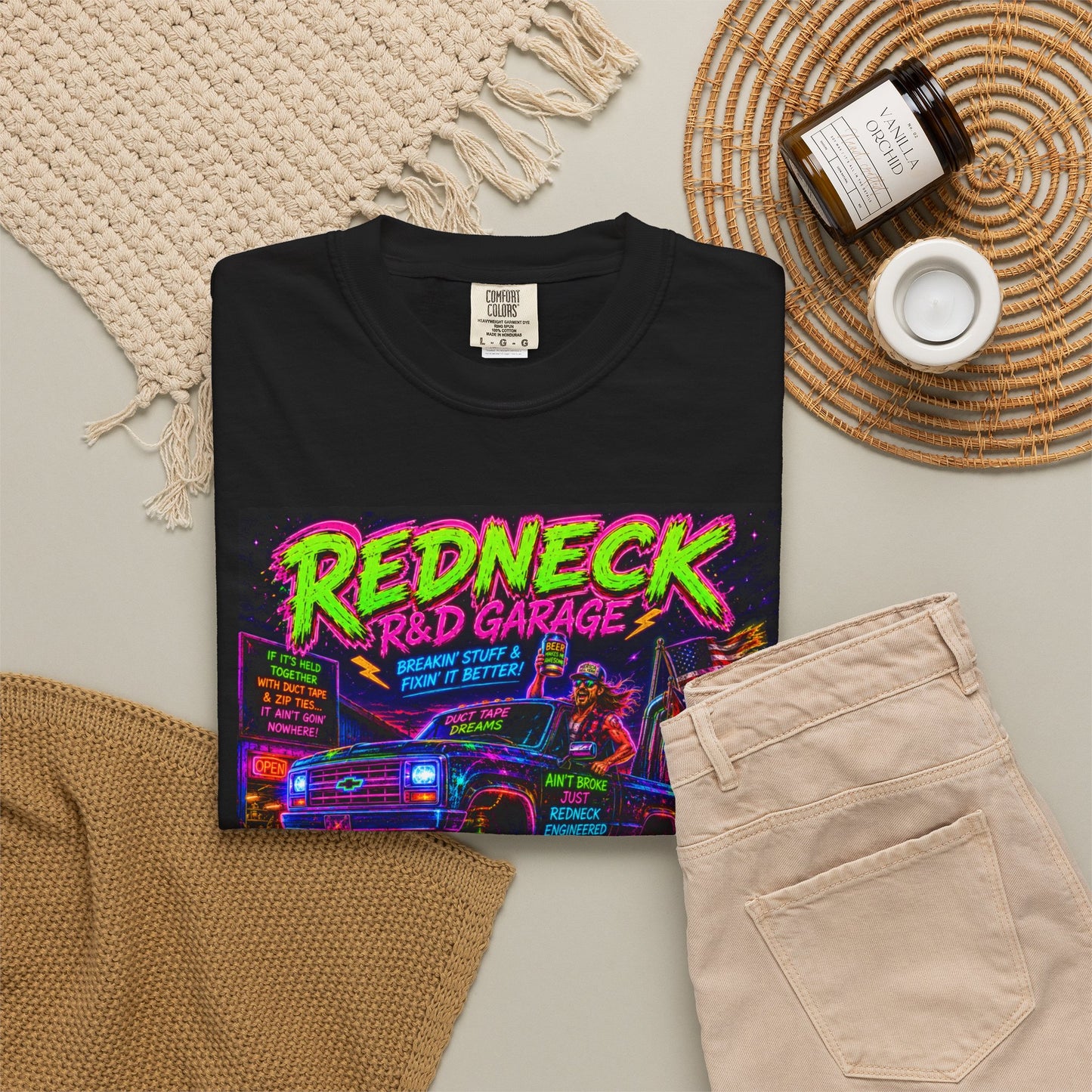 Vintage Garment-Dyed T-Shirt #13 in black featuring colorful "Redneck R&D Garage" graphic, styled with beige shorts and acces