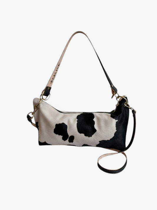 Blair Shoulder Bag featuring cow print hair-on hide with black leather accents and a detachable strap.