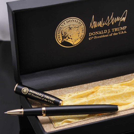Black executive pen with gold accents, featuring Donald Trump's name and logo, presented in a black box with gold lining.