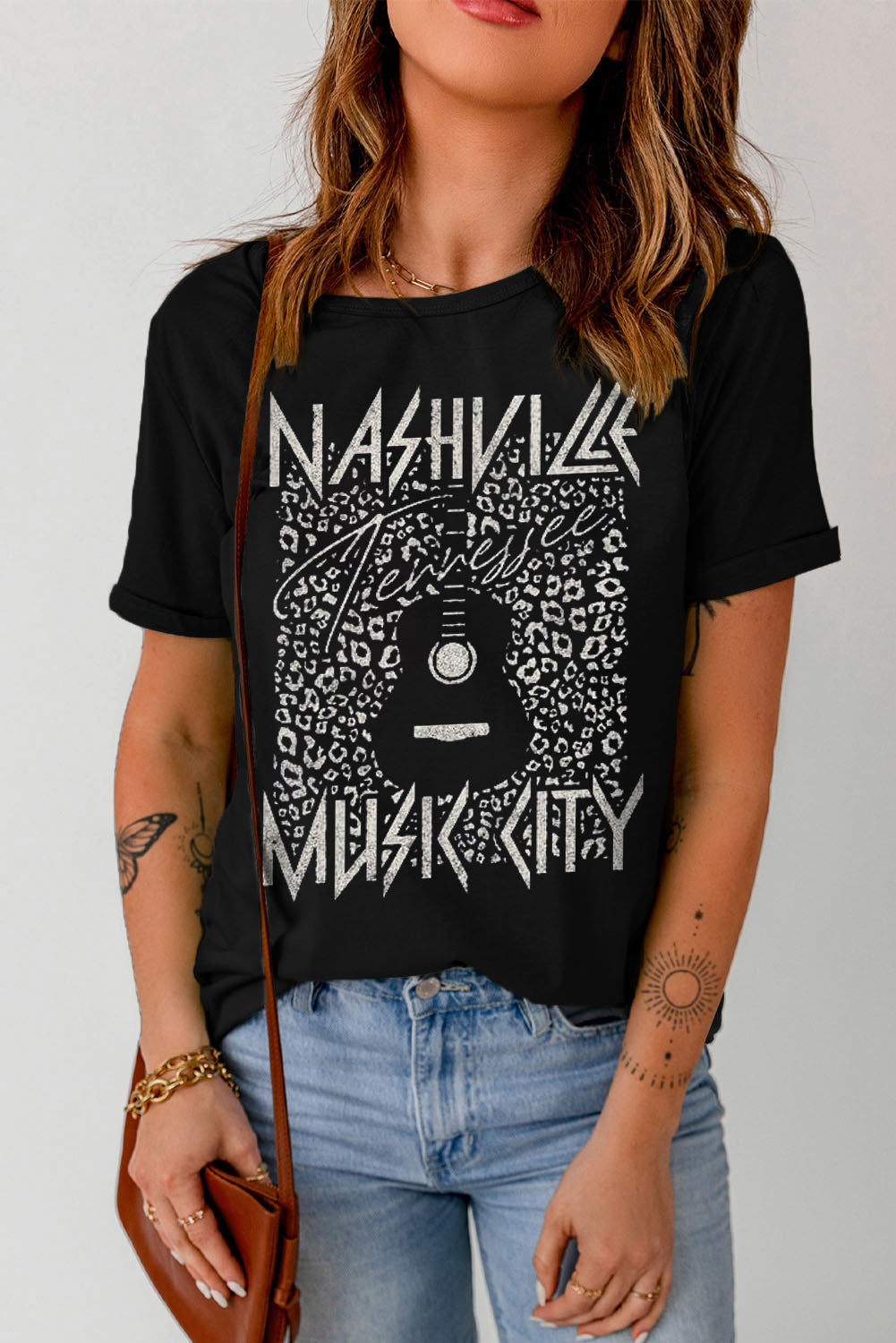 Black Graphic Cuffed Sleeve Round Neck Tee featuring "Nashville Music City" design with leopard print and guitar graphic.